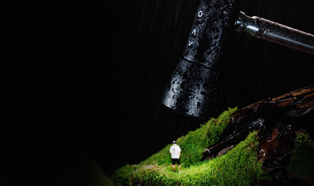 SmallRig RF 05B black weather-resistant light with visible water droplets and control buttons, mounted and operating in wet conditions