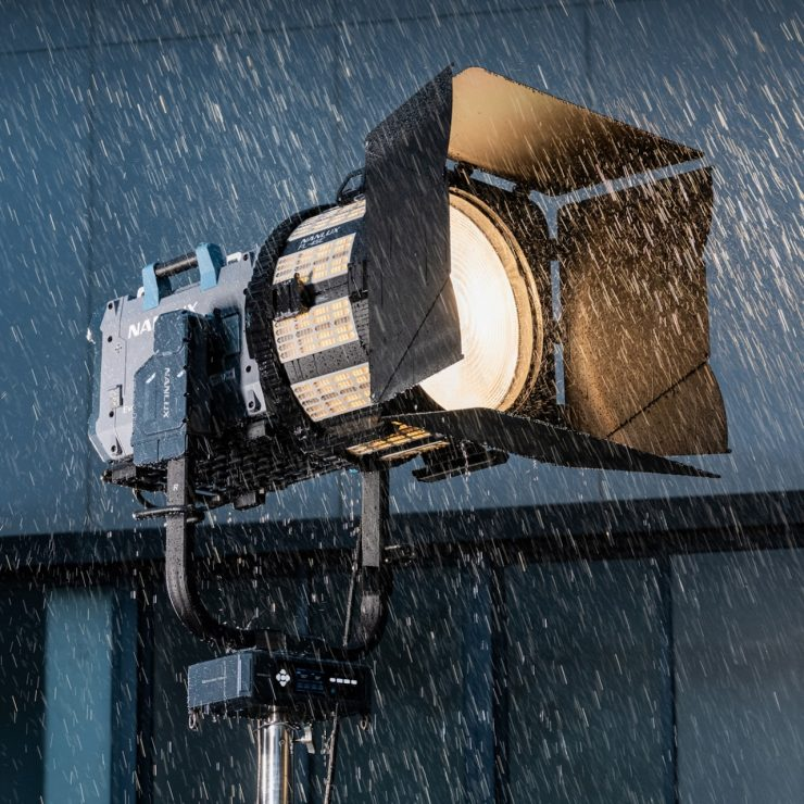 The Motorized Yoke-L and Nanlux Evoke series LED spotlight with barn doors being used in heavy rain on a film set